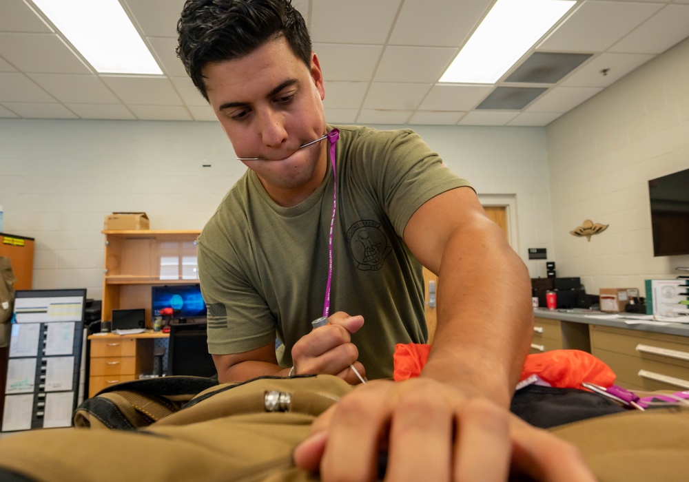 Aircrew flight equipment technician repacks a BA-30 Low Profile parachute