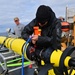 U.S. Navy launches an unmanned undersea vehicle from a Coast Guard Cutter in support of Op Nanook