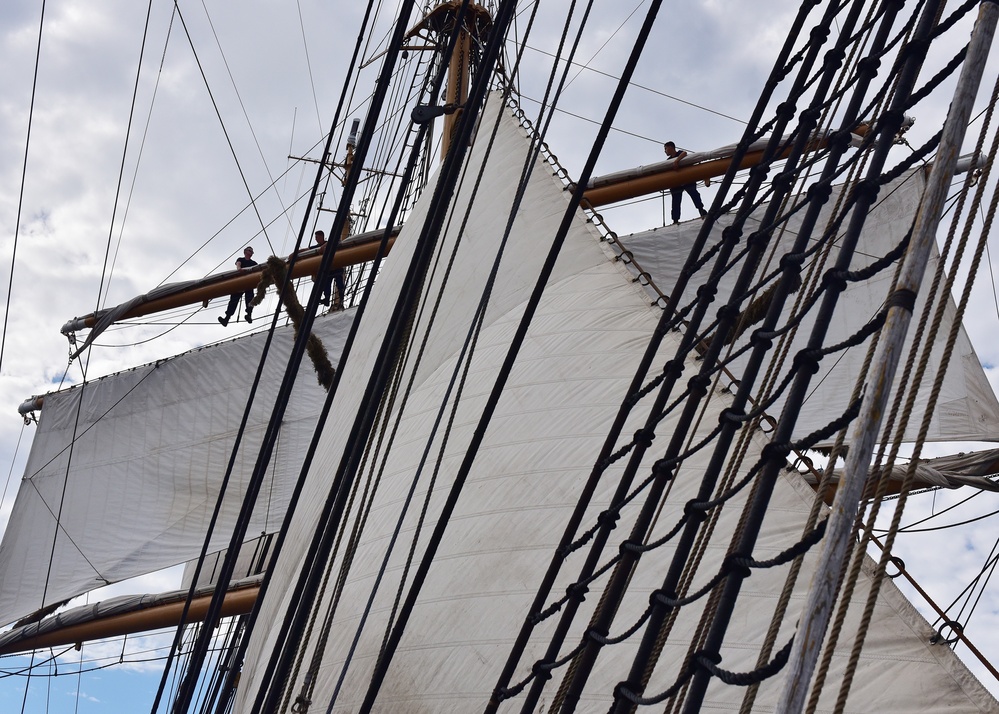 Eagle crewmembers work to set sail during training cruise