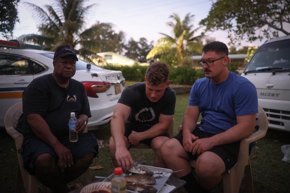 Dinner is Served: Marines enjoy a Mid-week meal with Peleliu Community