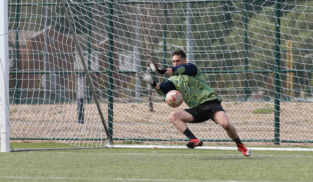 Kicking it: Soldiers play soccer