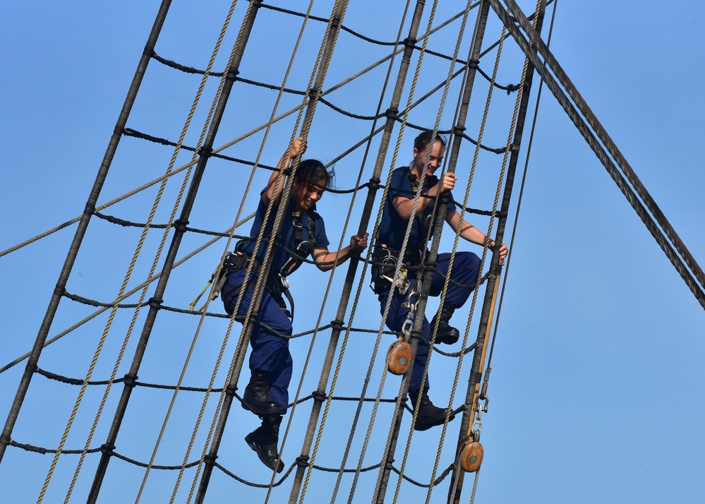 Crewmembers climb the rig, tend sail aboard America's Tall Ship, Coast Guard Cutter Eagle