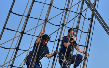 Crewmembers climb the rig, tend sail aboard America's Tall Ship, Coast Guard Cutter Eagle