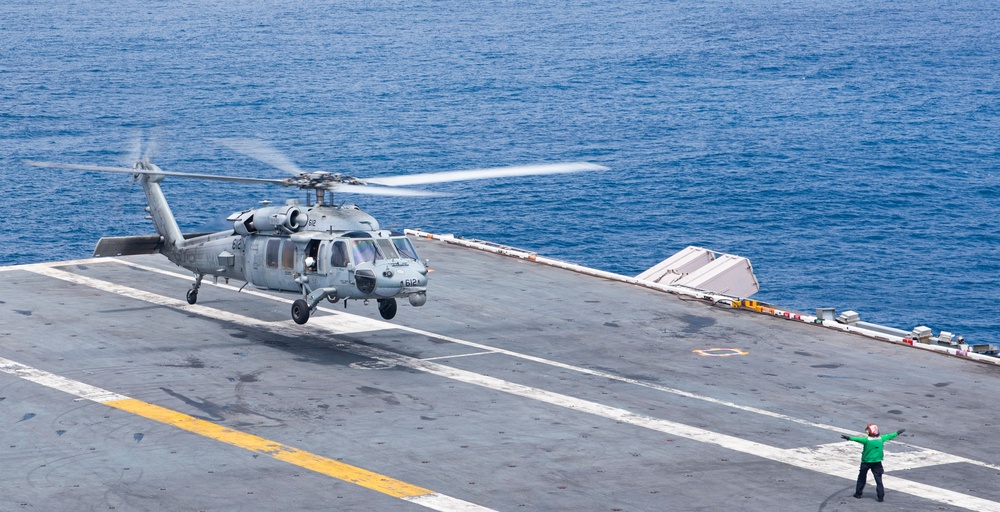 Helicopter launches from USS Nimitz flight deck