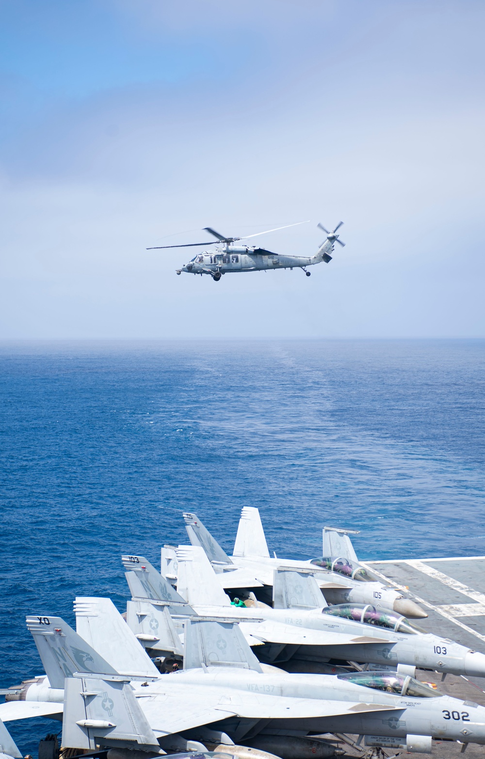 Helicopter launches from USS Nimitz flight deck