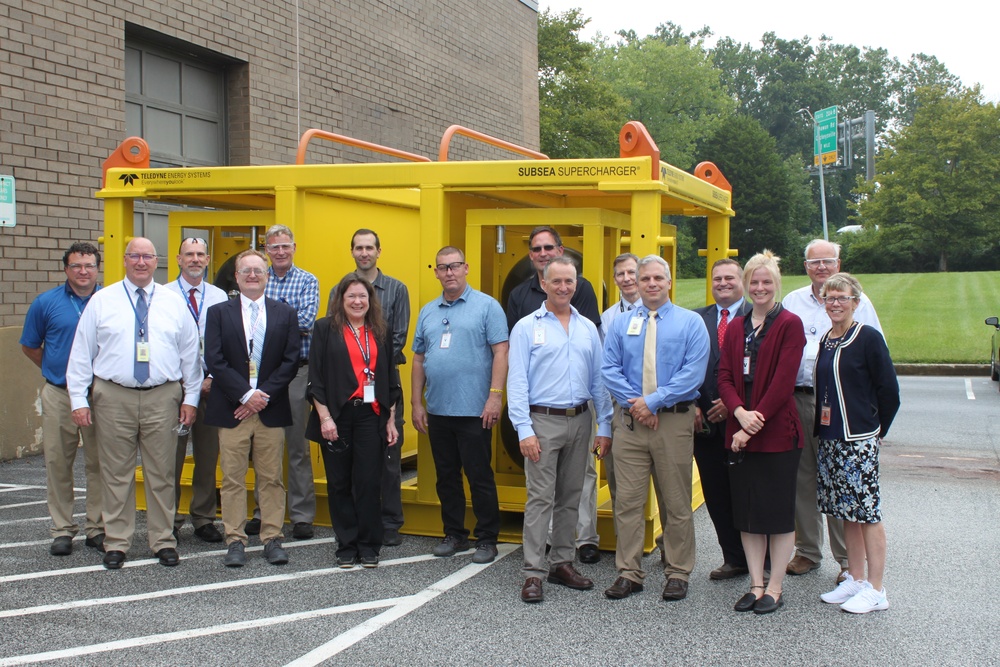 EXWC, DoD, and Teledyne personnel in front of Teledyne’s underwater fuel cell system