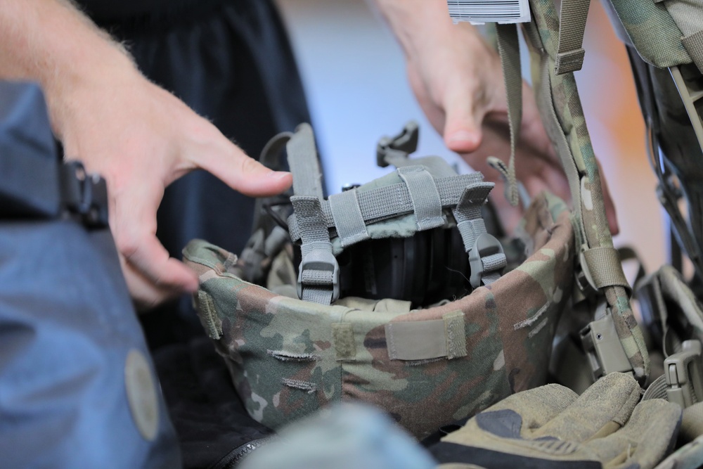 A competitor lays out their helmet during layout and inprocessing at the 2023 Army Reserve Best Squad Competition