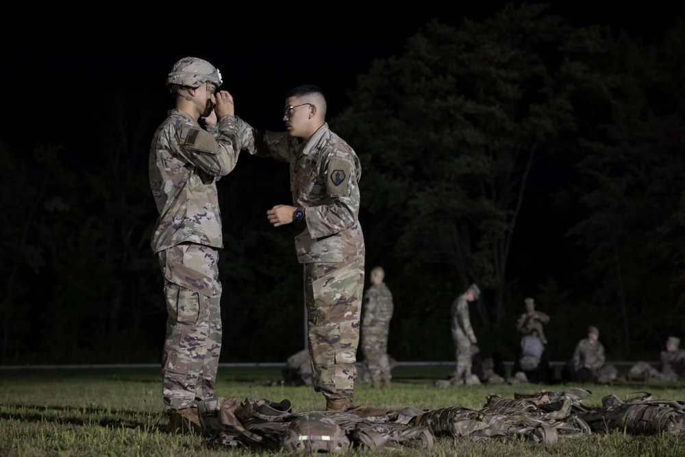 U.S. Army Reserve Spc. Nelson Medina assists Spc. Edgardo Santiago prior to an Expert Physical Fitness Assessment