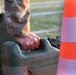 A U.S. Army Reserve soldier reaches for a water jug during an Expert Physical Fitness Assessment