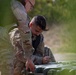 U.S. Army Reserve Best Squad competitor Spc. Johnathan Jones watches as Sgt. Alejandro Thaureauxlago tightens 550 cord