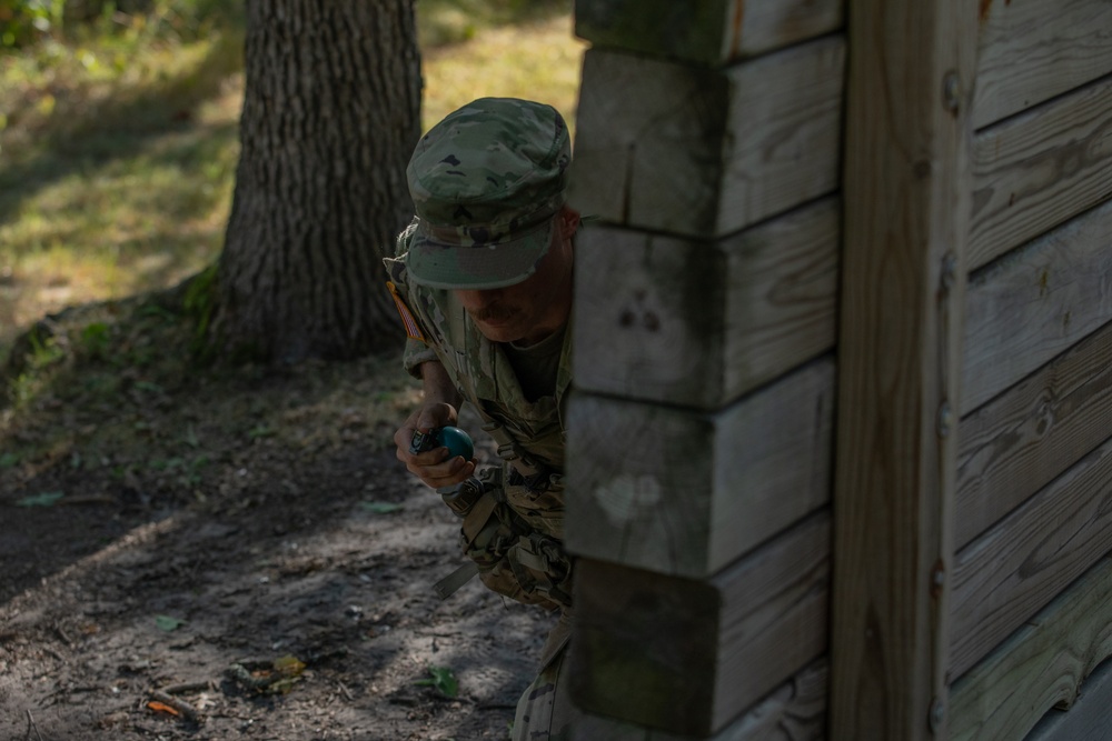 Cpl. Michael Glosemeyer simulates the steps a soldier takes prior to throwing a hand grenade.