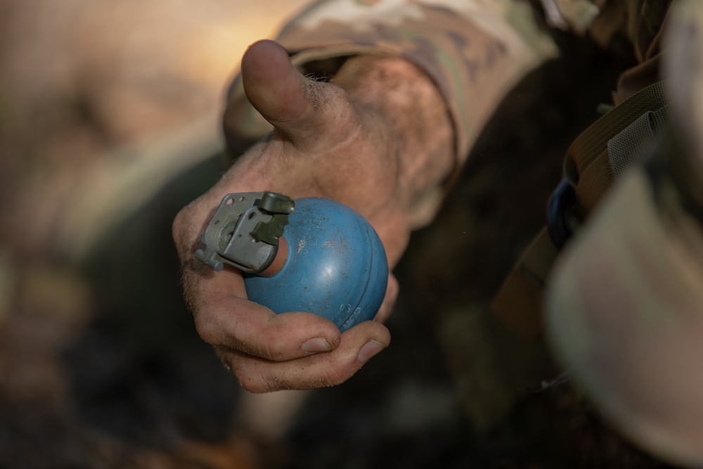 A U.S. Army Reserve Best Squad competitor simulates the steps a soldier takes prior to throwing a hand grenade.