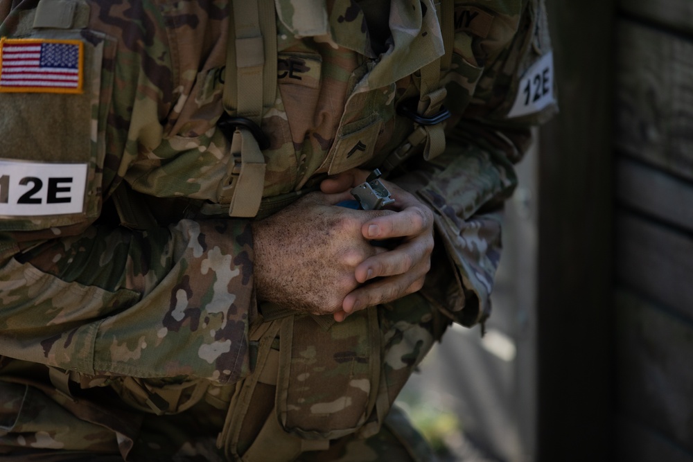 A U.S. Army Reserve Best Squad competitor simulates the steps a soldier takes prior to throwing a hand grenade.