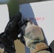 Spc. Robert Broughton writes on a target