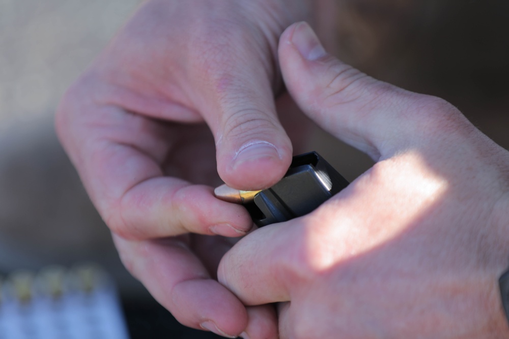 Spc. Coby Ecestein loads an M17 magazine