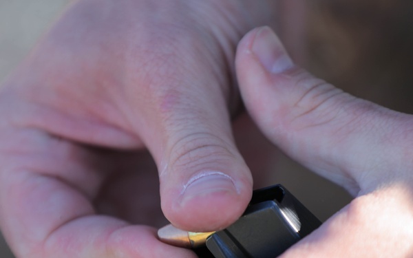 Spc. Coby Ecestein loads an M17 magazine