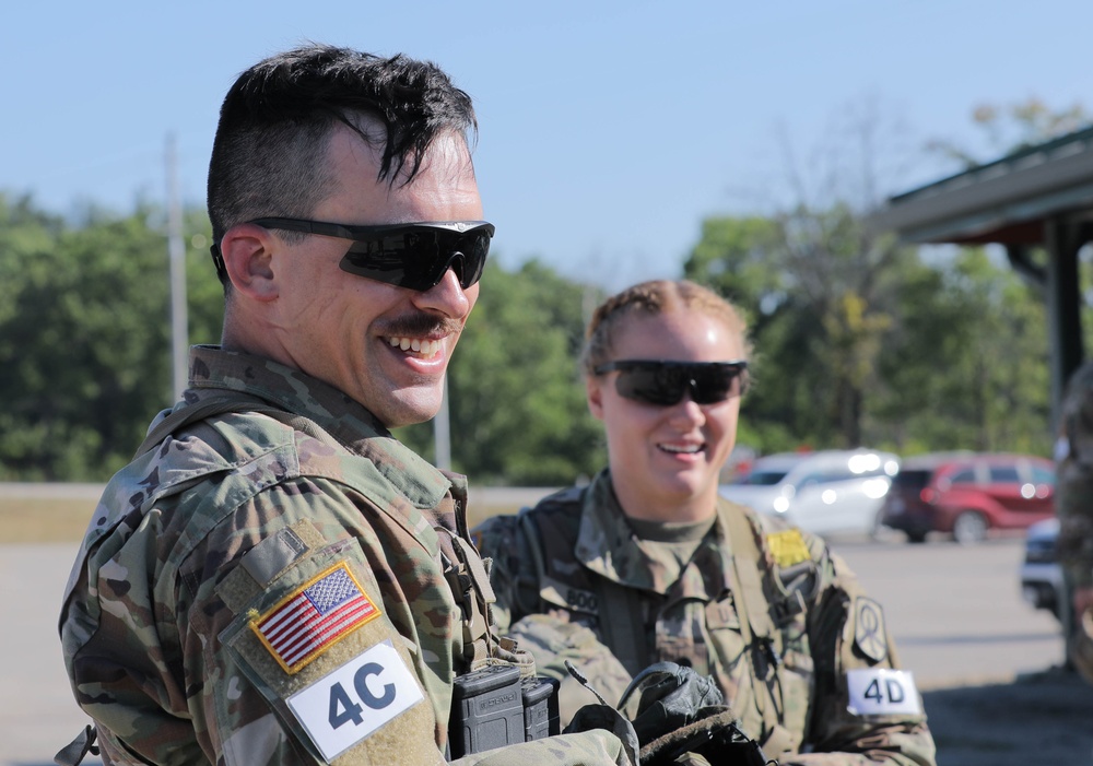 Spc. Trenton Rumba and Spc. Kynzi Booth relax after shooting