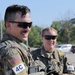 Spc. Trenton Rumba and Spc. Kynzi Booth relax after shooting
