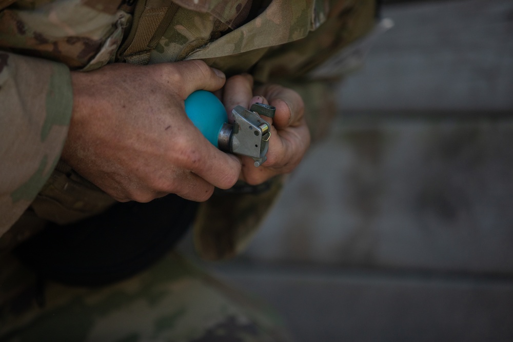 A U.S. Army Reserve Best Squad competitor simulates the steps a soldier takes prior to throwing a hand grenade.