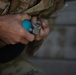 A U.S. Army Reserve Best Squad competitor simulates the steps a soldier takes prior to throwing a hand grenade.