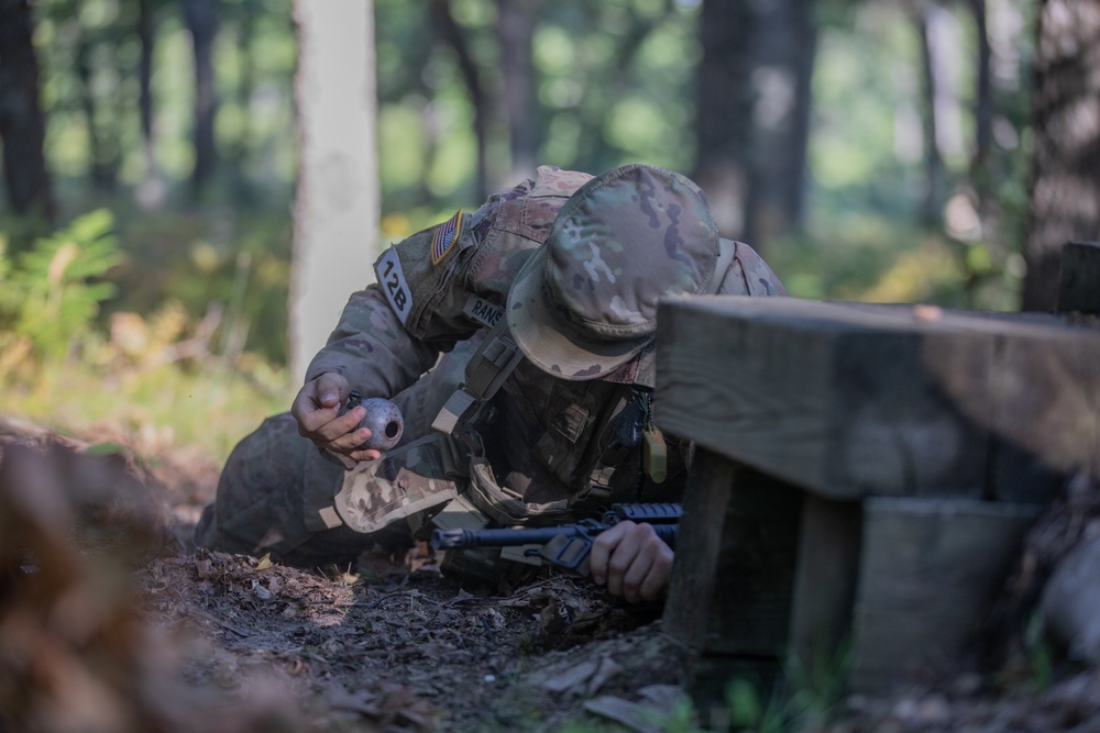 Sgt. James Ranstead simulates the steps a soldier takes prior to throwing a hand grenade.