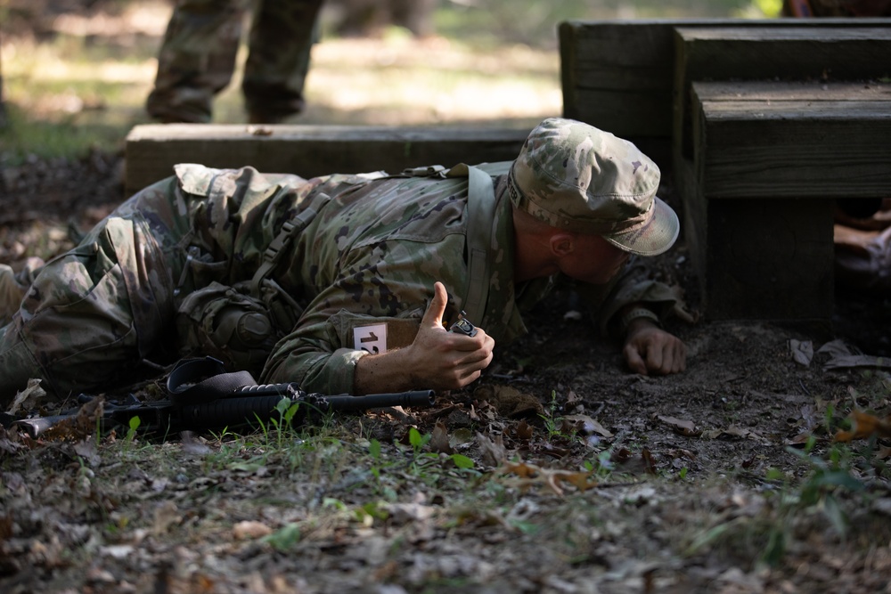 Cpl. Michael Glosemeyer simulates the steps a soldier takes prior to throwing a hand grenade.