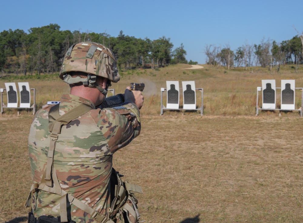 Spc. Nathaniel Wells shoots an M17 pistol