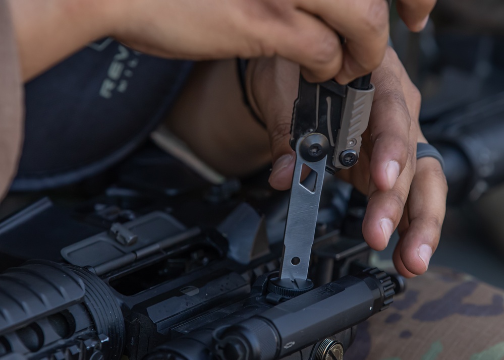 A U.S. Army Reserve Best Squad competitor adjusts the sights of his M4 rifle