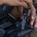 A U.S. Army Reserve Best Squad competitor adjusts the sights of his M4 rifle