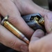 A U.S. Army Reserve Best Squad competitor loads the magazine of his M4 rifle