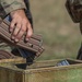 A U.S. Army Reserve Best Squad competitor drops his empty M4 rifle magazines into a collection box