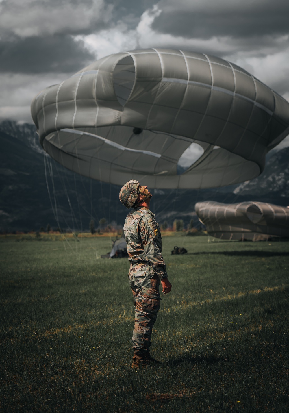 Sky Soldier Looks Up At Fellow Paratroopers