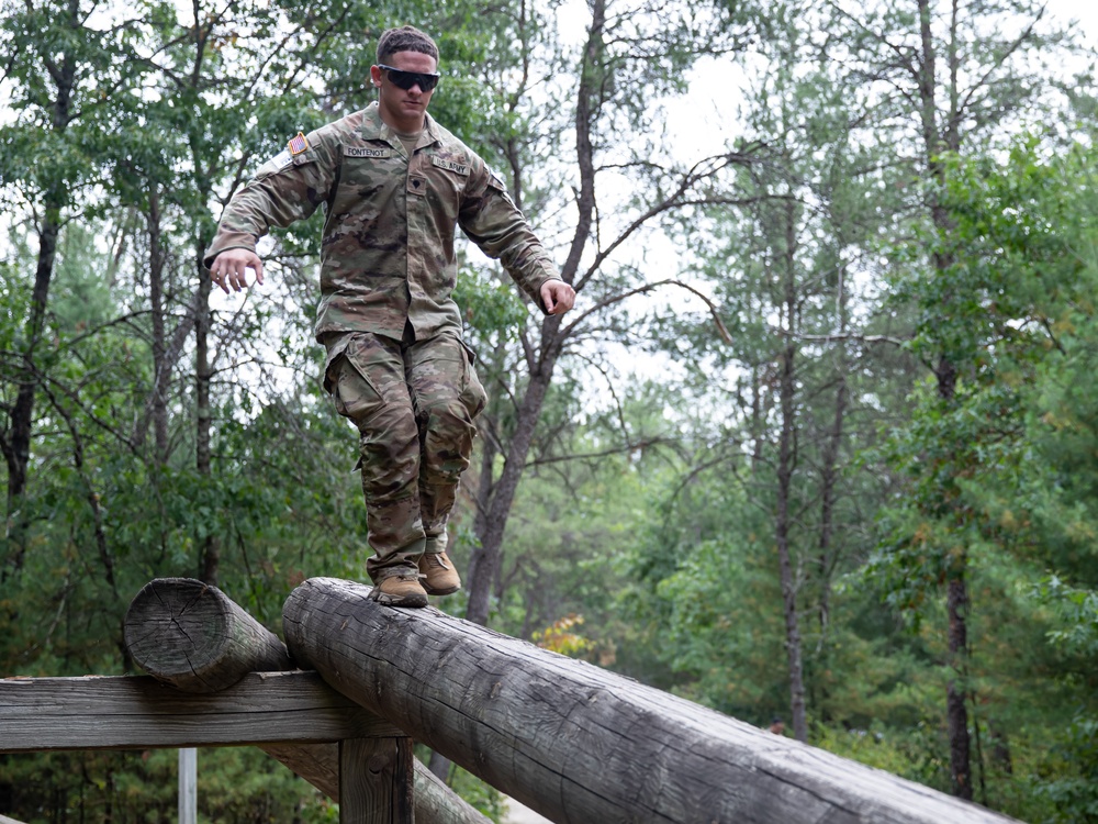 Army Spc. Jacob Fontenot conducts an obstacle course