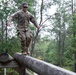 Army Spc. Jacob Fontenot conducts an obstacle course