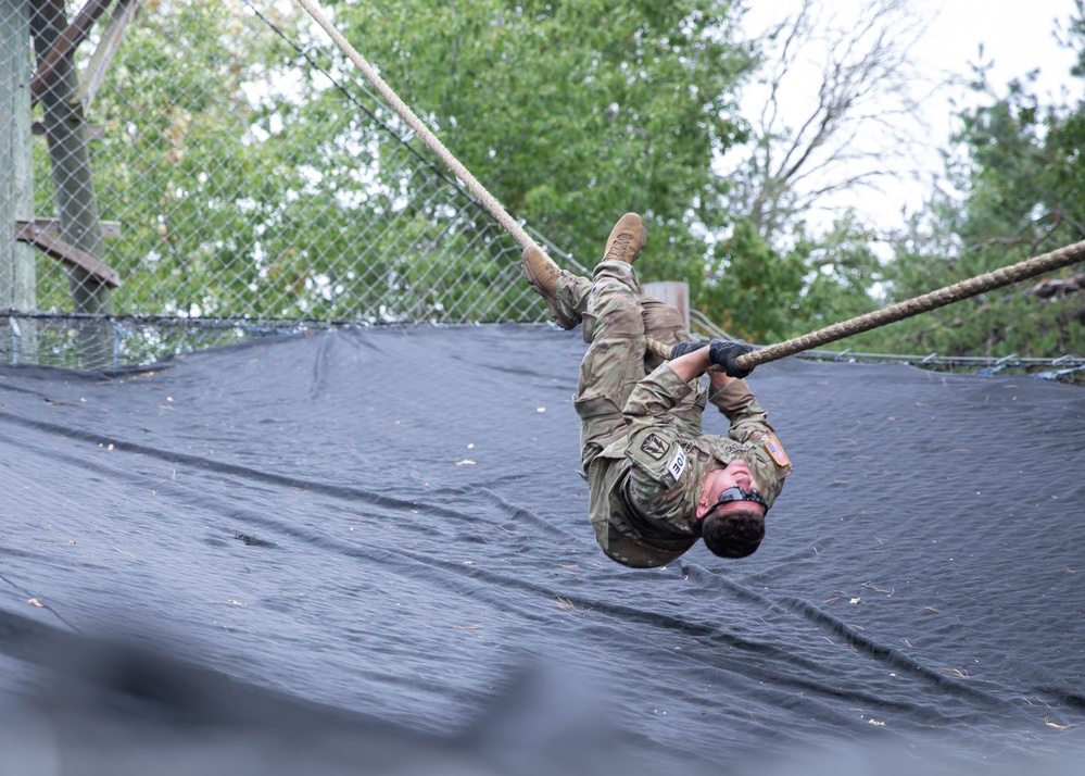 Army Spc. Jacob Fontenot conducts an obstacle course