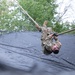 Army Spc. Jacob Fontenot conducts an obstacle course