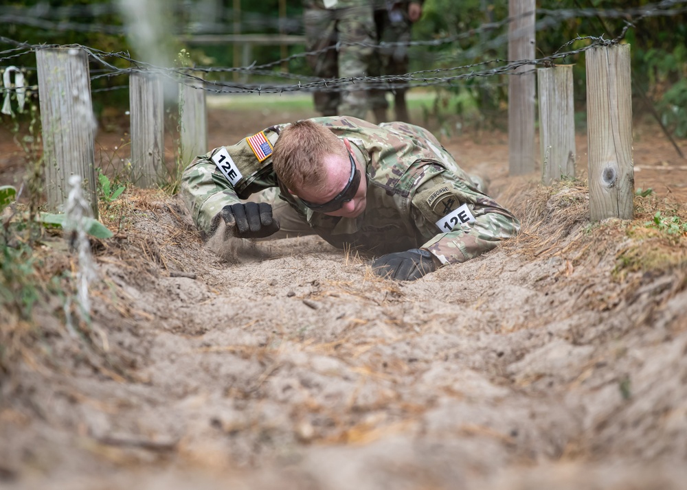 Cpl. Ryan Fordyce low-crawls under barbed wire