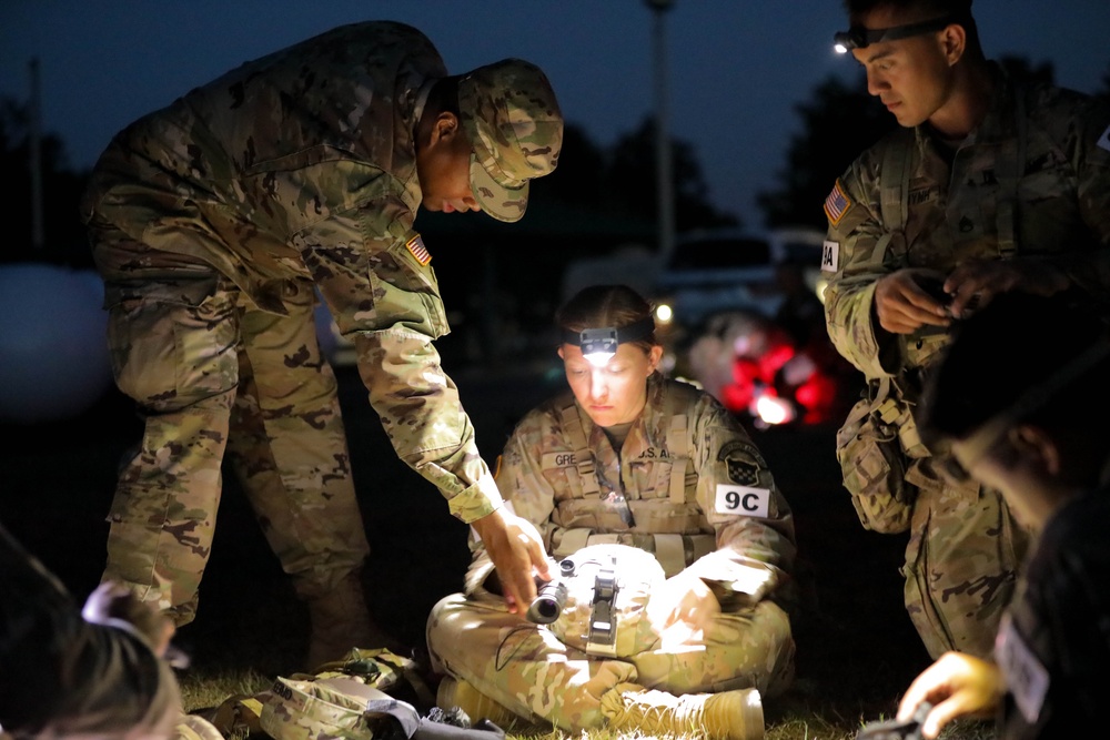 Sgt. Emily Green receives instruction on assembling a Night Observation Device