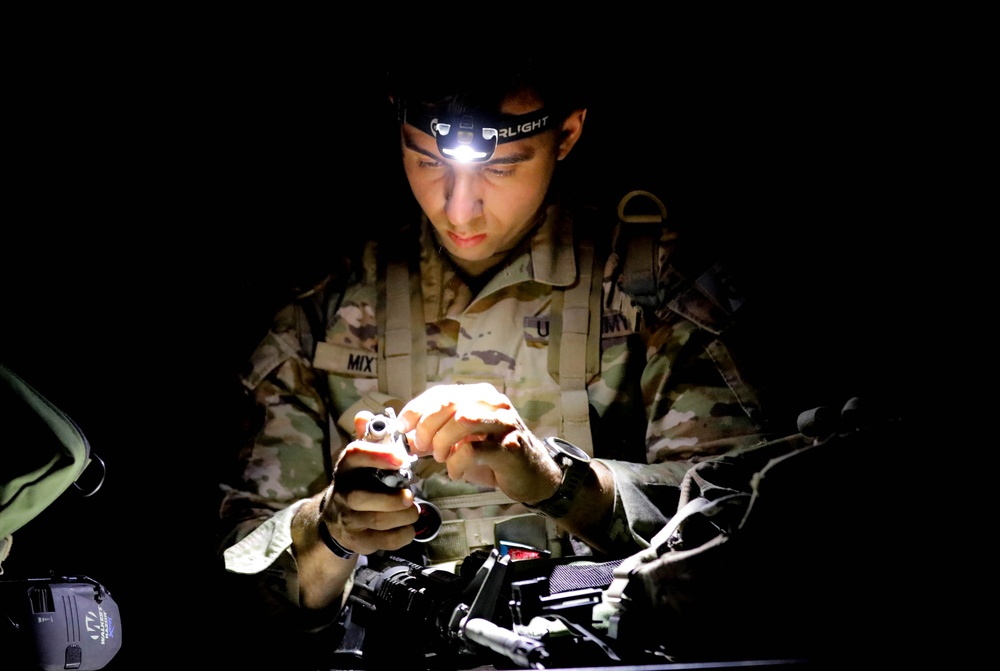 Spc. Stephan Mixter assembles a Night Observation Device during the M4 Night Qualification event