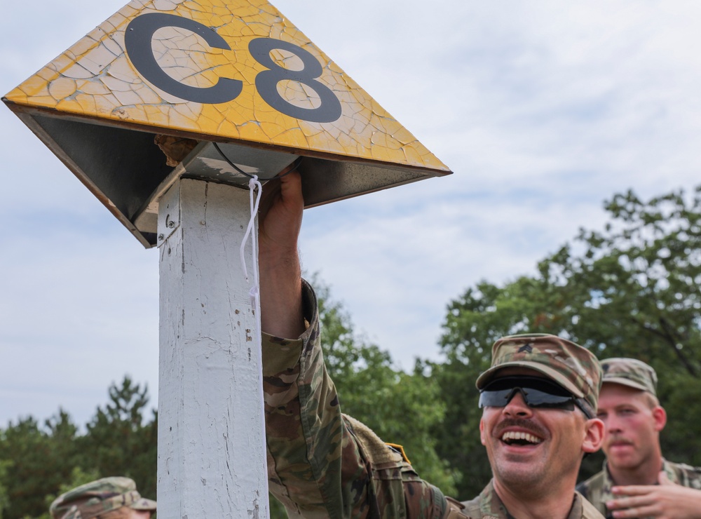 Spc. Trenton Rumba celebrates finding a checkpoint during the day land navigation event