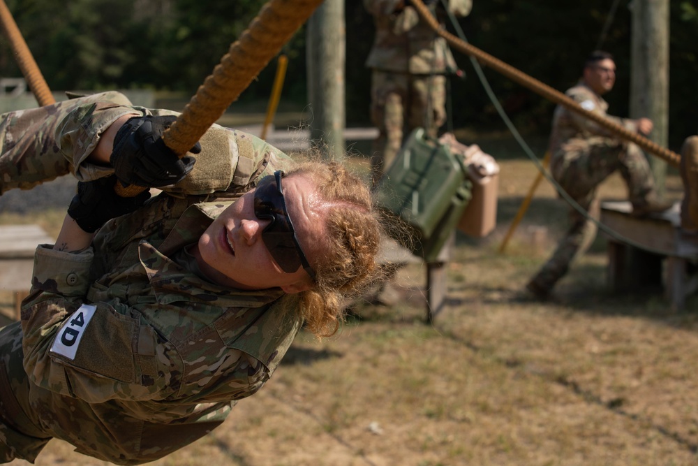 Spc. Kynzi Booth herself across a suspended rope