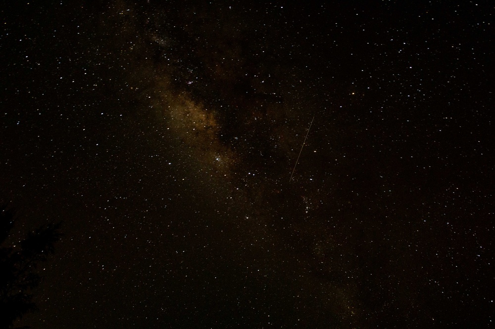 Meteors pass of Pacific Missile Range Facility, Barking Sands, during the Perseid Meteor Shower.