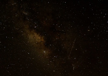 Meteors pass of Pacific Missile Range Facility, Barking Sands, during the Perseid Meteor Shower.