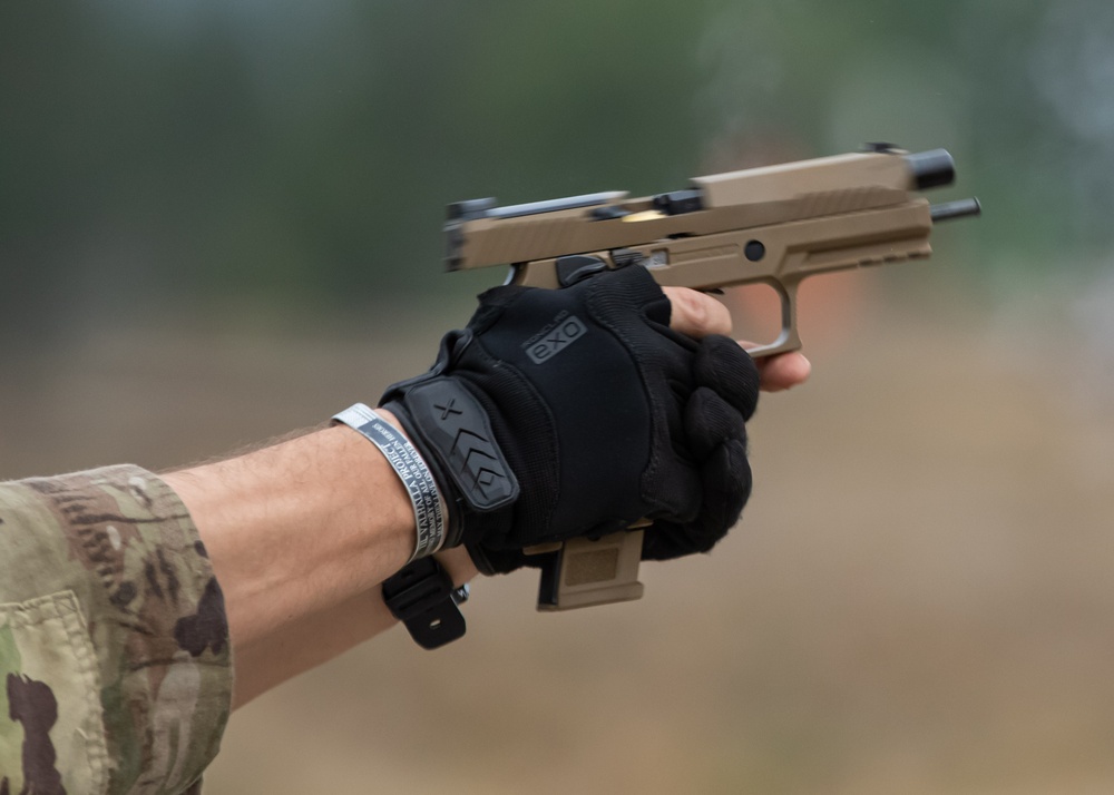 Army Spc. Carlin Houston fires the M17 pistol