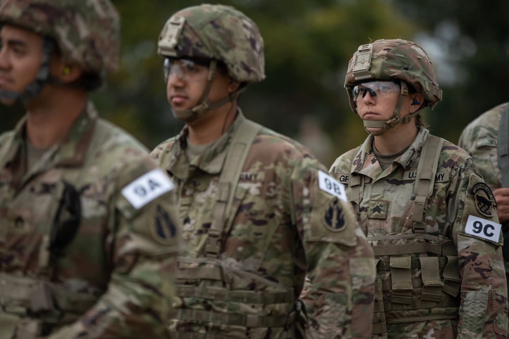 Sgt. Emily Green waits in line to receive ammunition