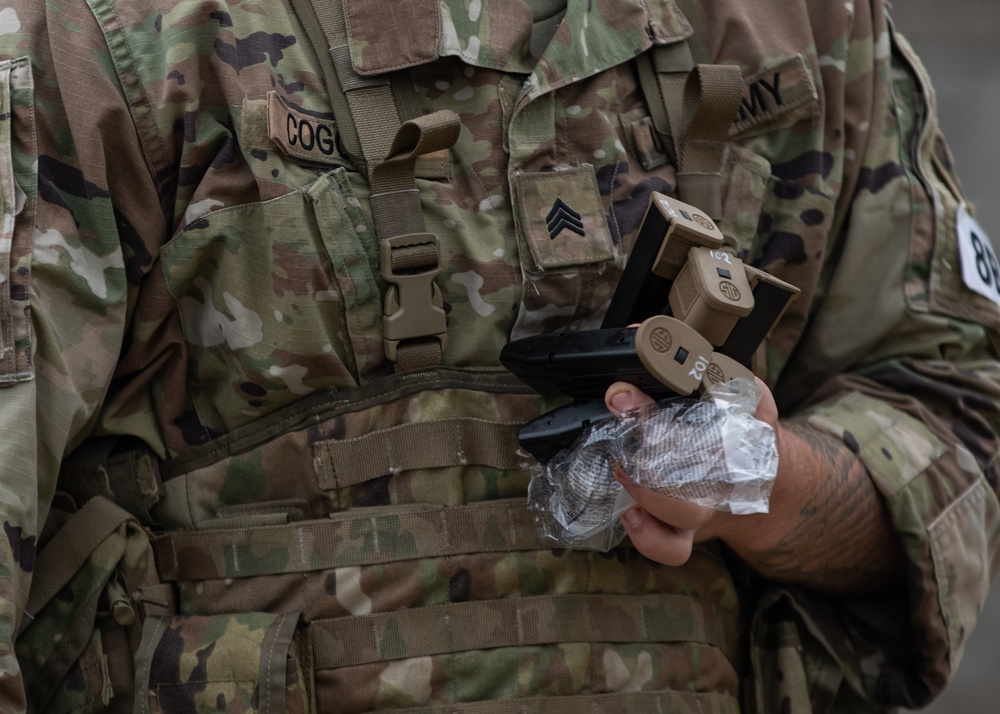 Army Sgt. Timothy Coggins qualifies with the M17 pistol