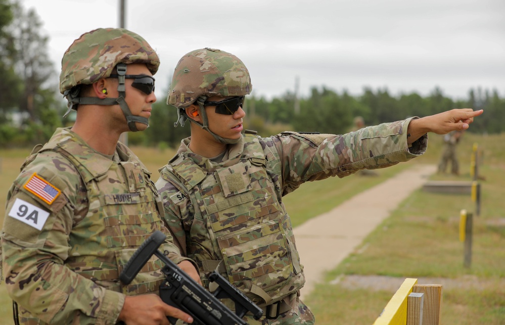 Staff Sgt. Jimmy Huyn listens to instructions prior to shooting an M320A1