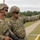 Staff Sgt. Jimmy Huyn listens to instructions prior to shooting an M320A1