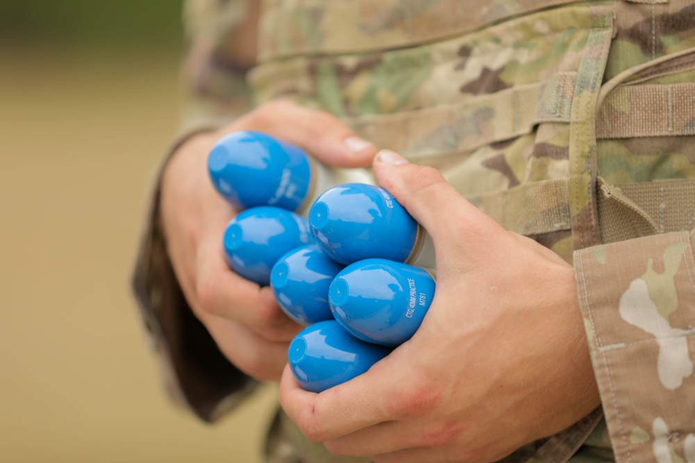 Spc. Matthew Dillon holds M781 practice rounds prior to shooting an M320A1