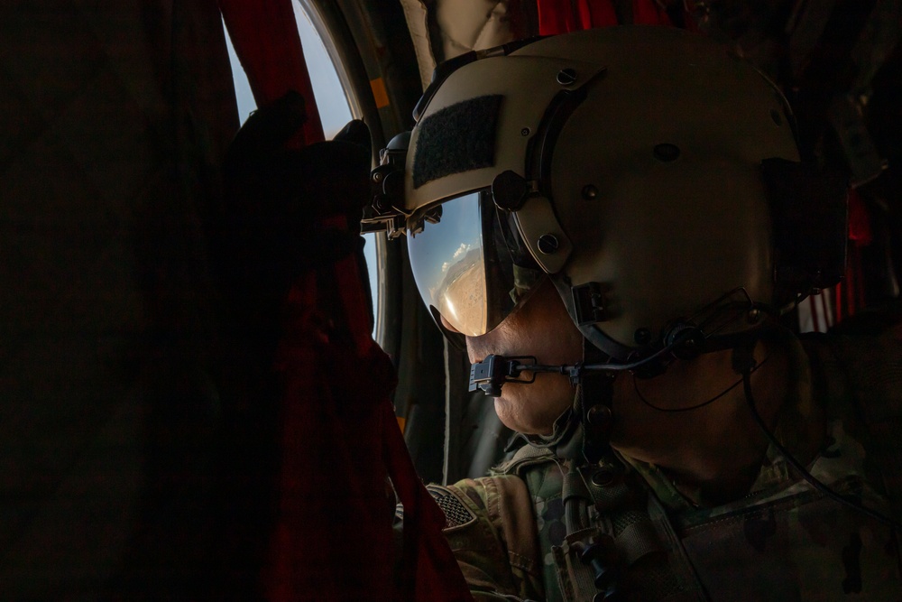 U.S. Army Crew Chief scans the desert